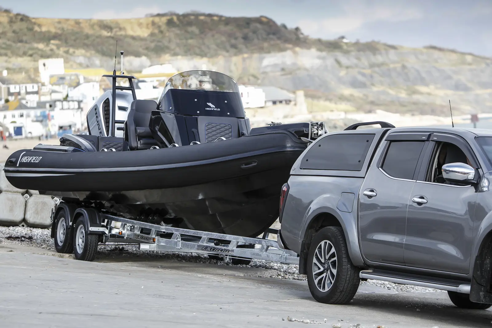 Boat and Extreme trailer beside the coast